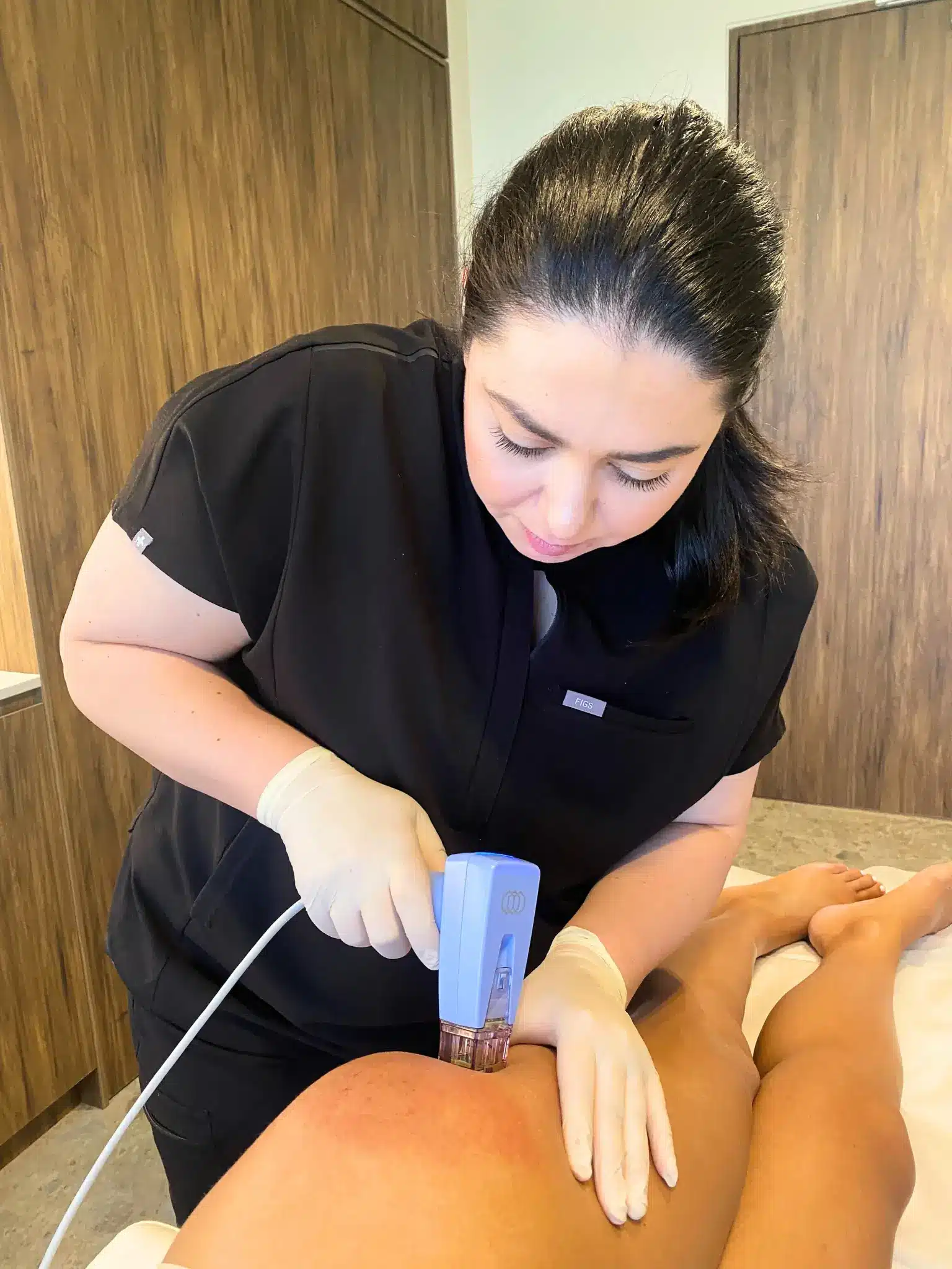 Dermal therapist treating a patient's leg with Morpheus8 for body fat remodelling and skin laxity
