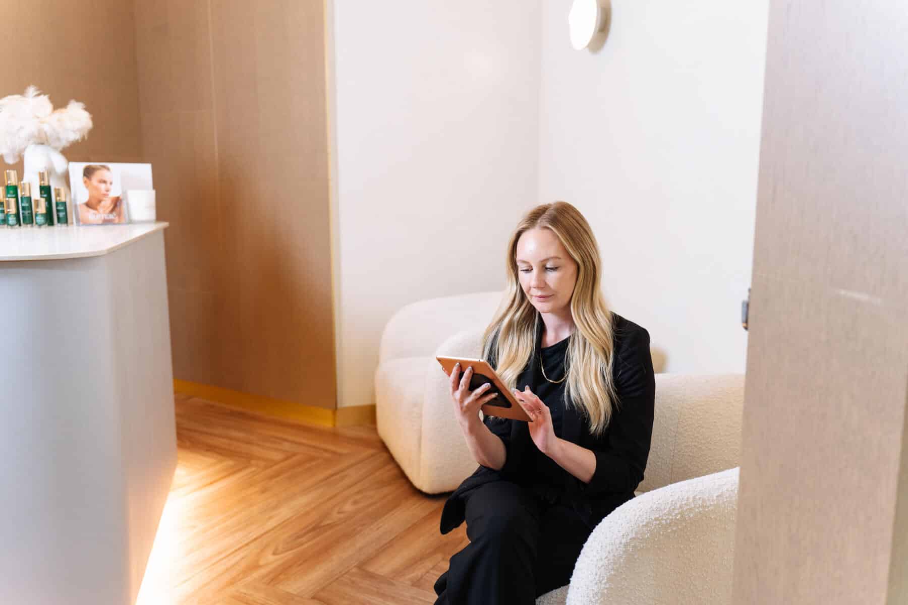 Patient in patient lounge at skin and laser clinic Narellan, waiting for cosmetic procedure