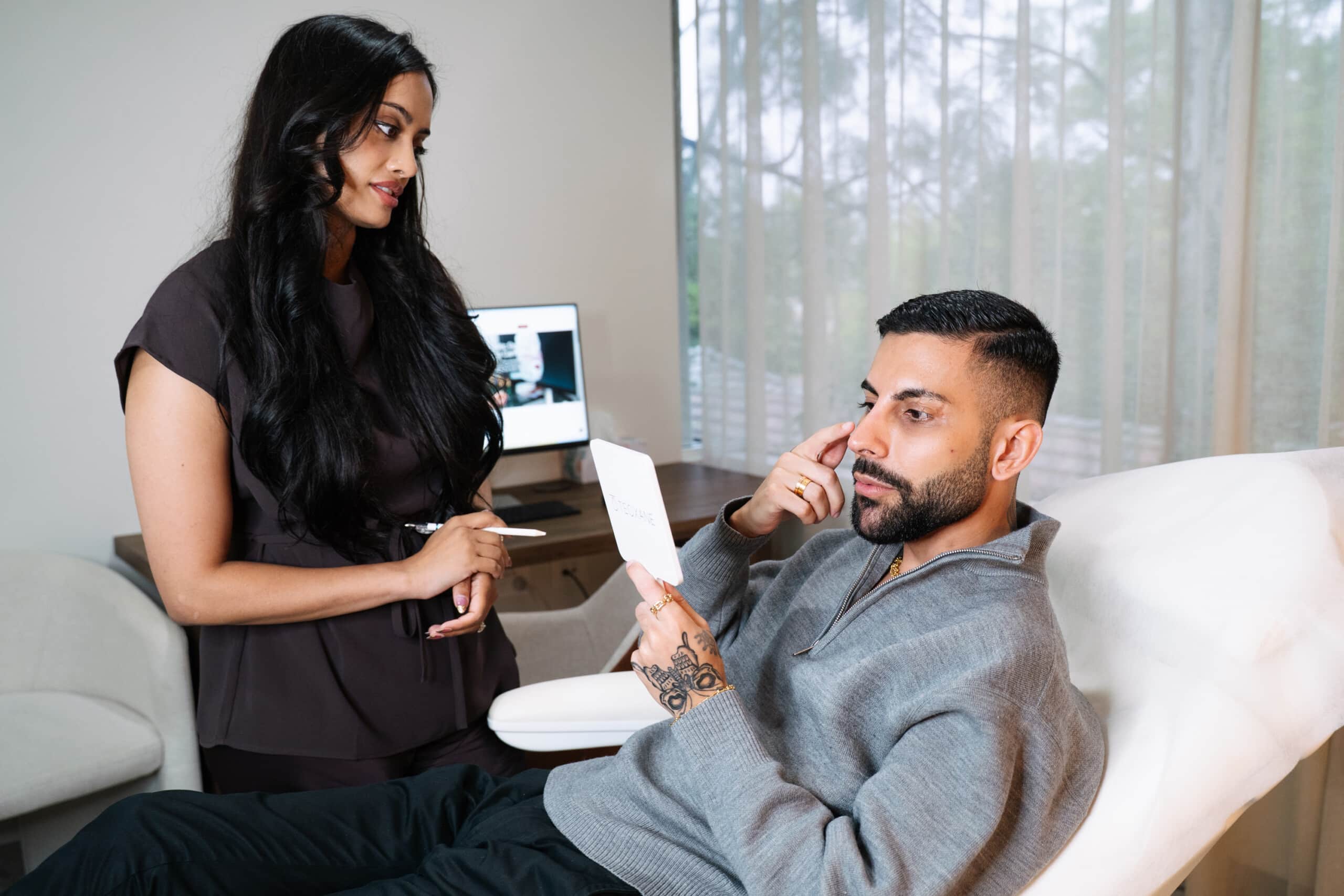 Cosmetic doctor from Contour Clinics consulting a patient about upper eyelid and eyelid volumisation