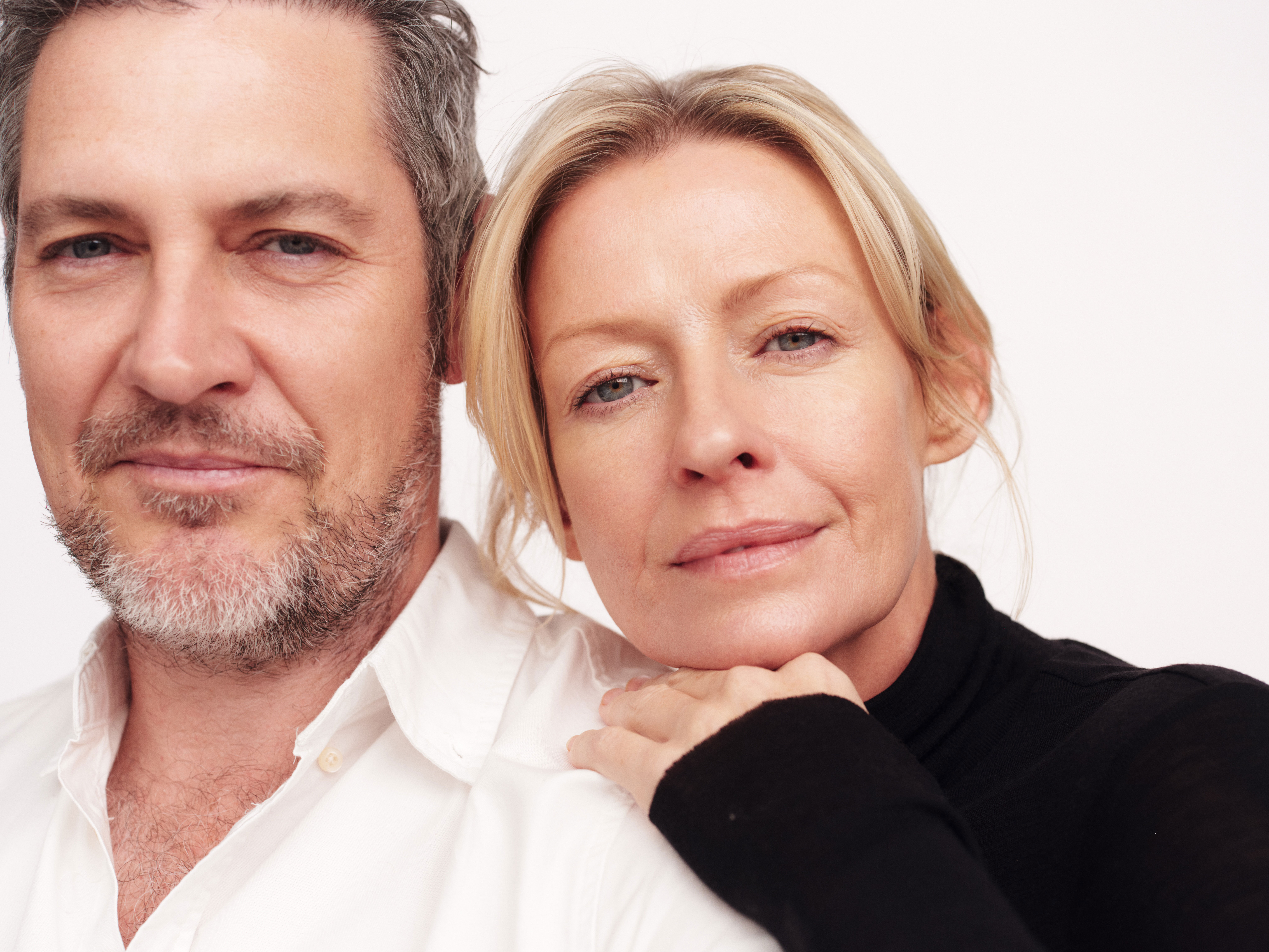 Male and female in their late forties, staring into the camera