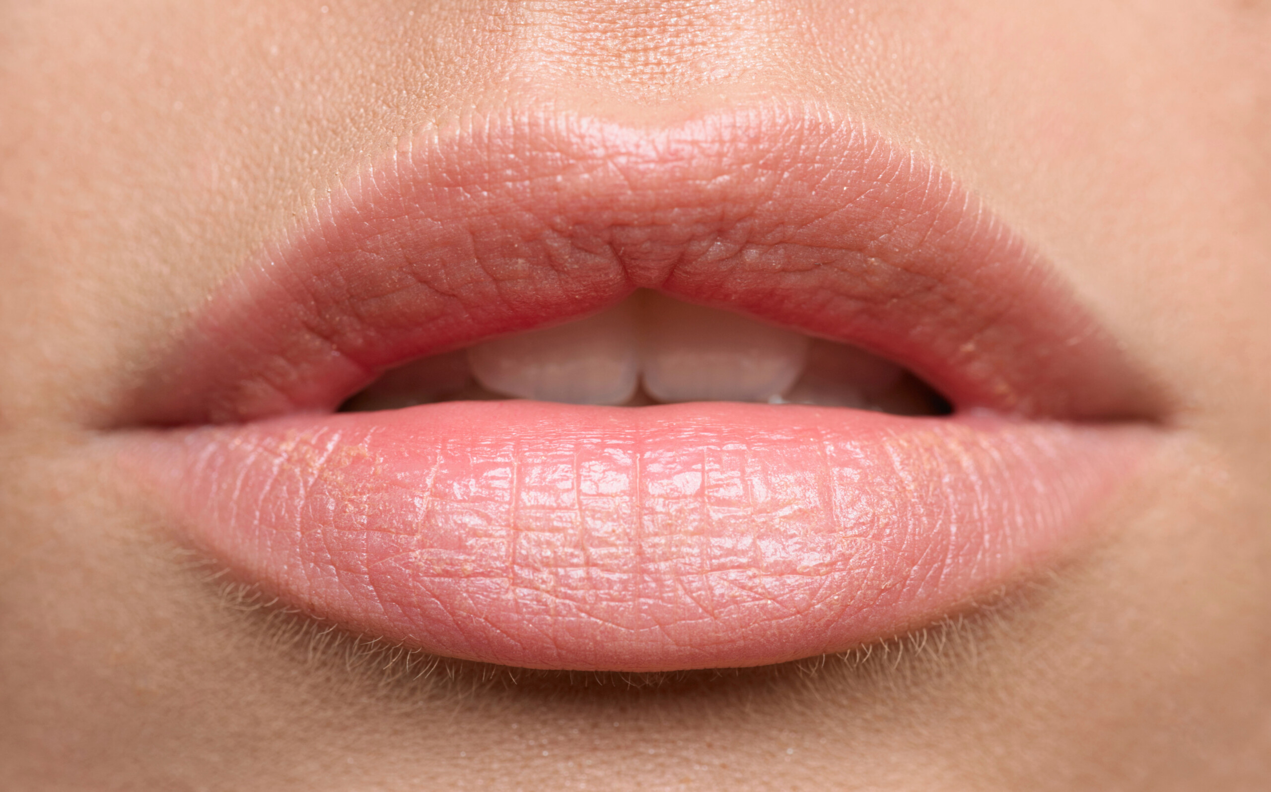 Close up shot of womans lips, she has a defined cupid's bow and hydrated lips